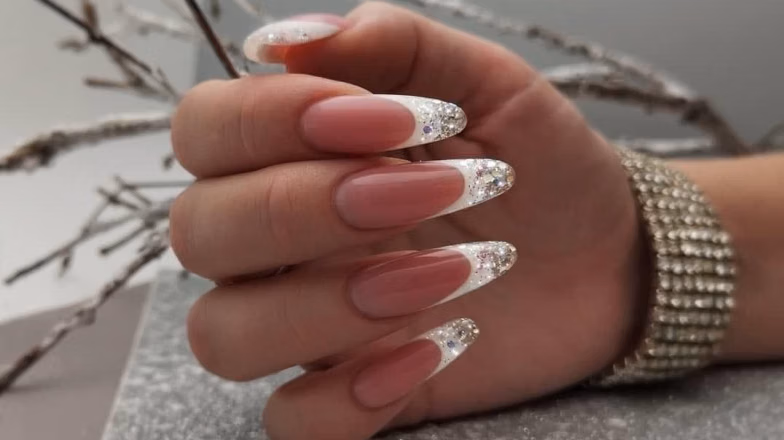 Transparent nude nails with metallic silver French tip design