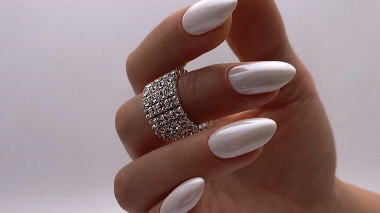 Minimalist white manicure on almond-shaped nails with glossy finish