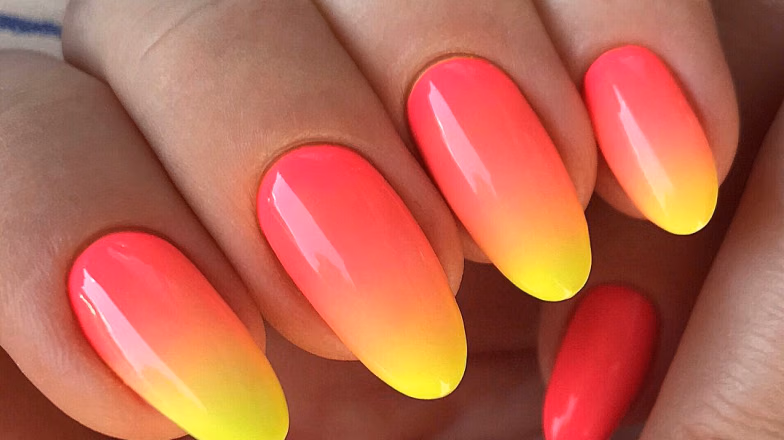 Bright ombre nails with neon pink, orange, and yellow gradient design