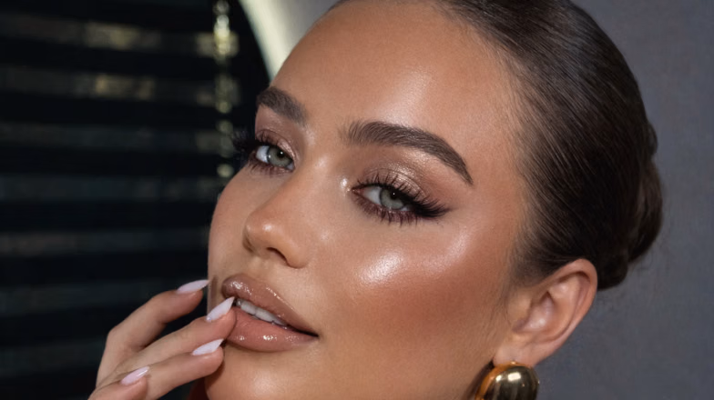 Woman with sultry eye makeup featuring smoky eyeshadow and glowing skin for evening look