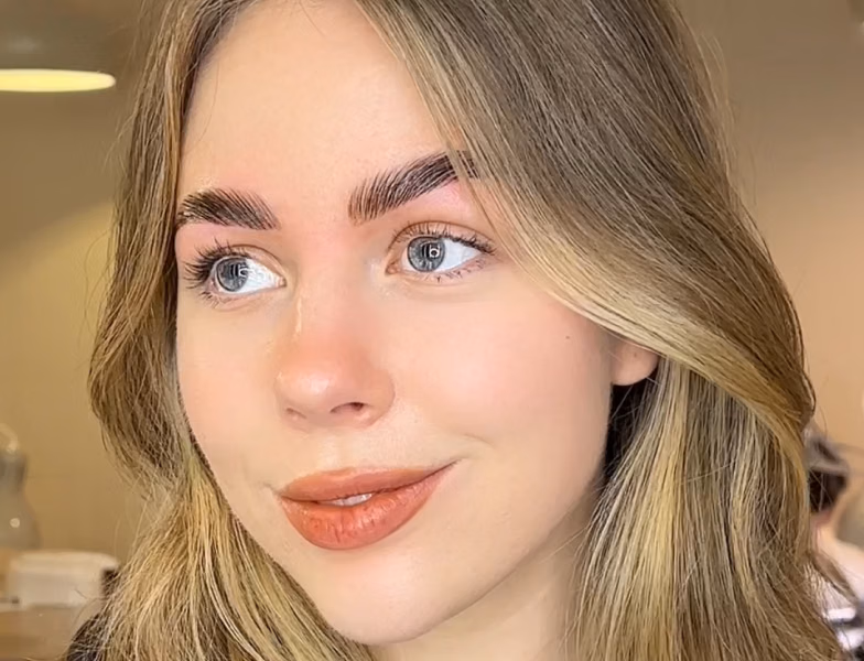 Woman with perfectly shaped and laminated eyebrows, showcasing natural brow styling and eyebrow services in Dubai beauty salon