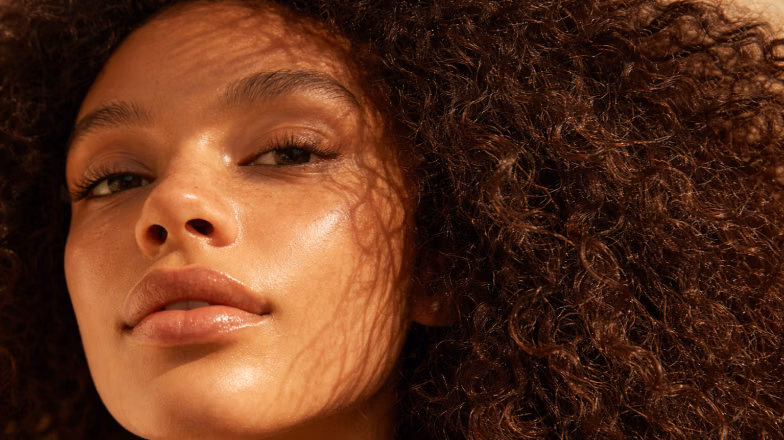 Close-up of glowing skin with natural makeup, highlighting facial features and skin texture