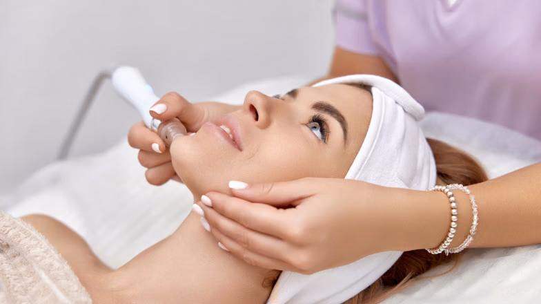 Professional facial treatment performed by beautician in a modern beauty salon in Dubai