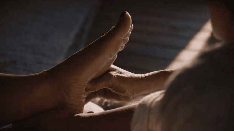 Relaxing foot massage with therapist applying gentle pressure in a spa setting
