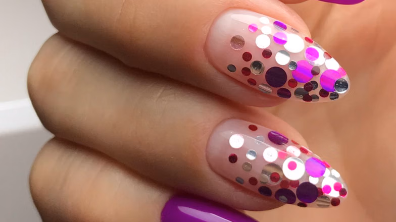 Long nails with pink base and metallic dot nail art design