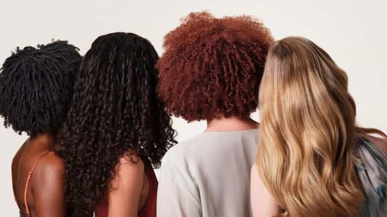 Different hair types and colors from back view showing natural texture and hair color variation