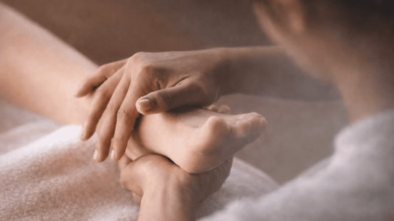 Spa-style foot massage with essential oils and relaxing treatment setup