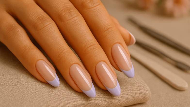 Close-up of nude manicure with soft glossy finish, showcasing minimalistic nail art design in salon