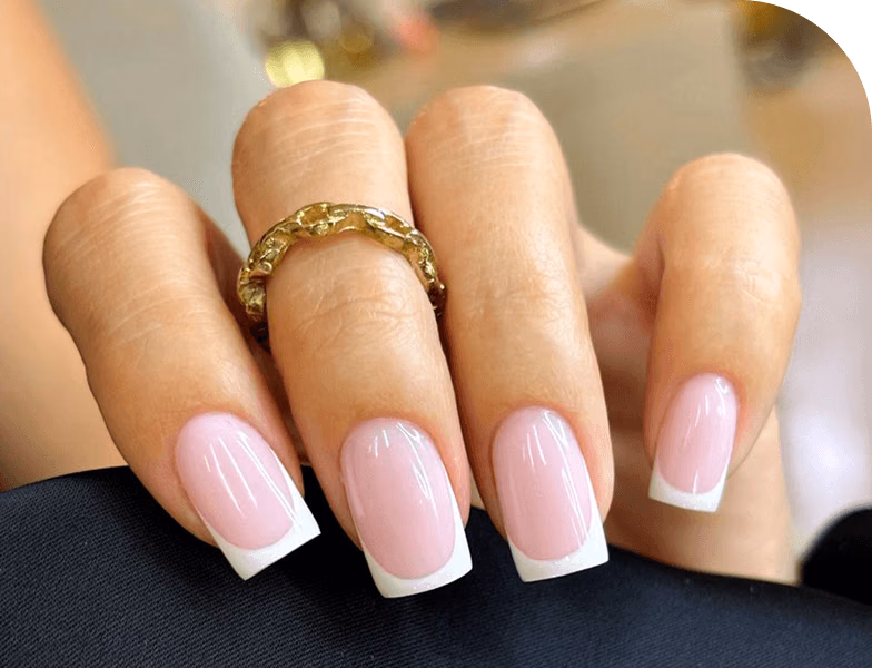 Hand with pink gel nail extensions and square shape tips, showcasing glossy finish and professional nail enhancement service