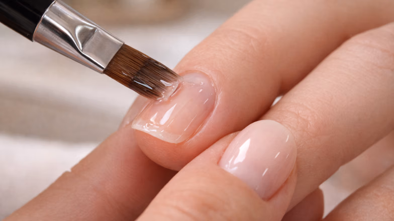 Close-up of nail splitting at the tip during manicure treatment in a beauty salon