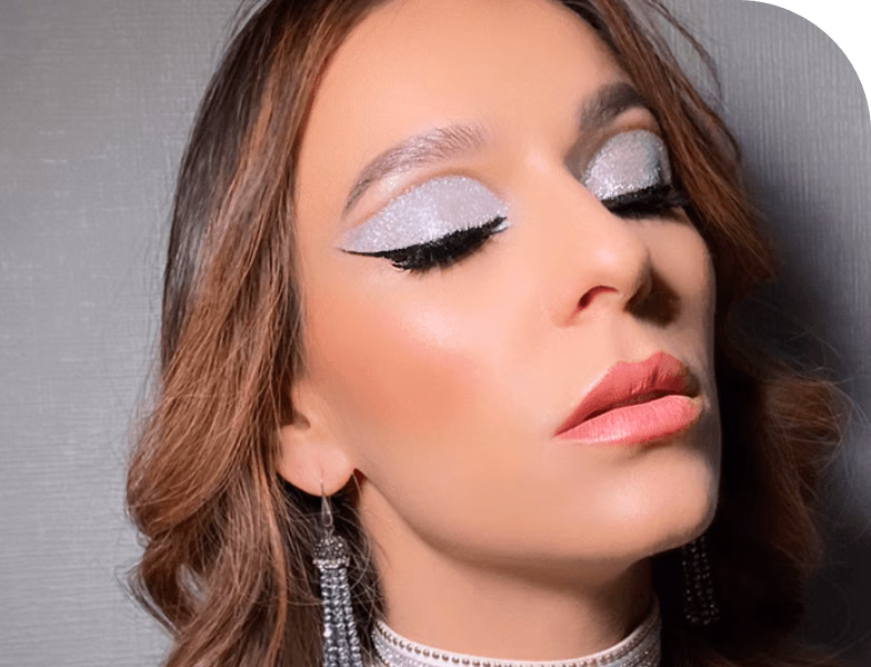Woman with glamorous evening party makeup featuring bold eyeshadow and glowing skin, showcasing professional party makeup services in Dubai