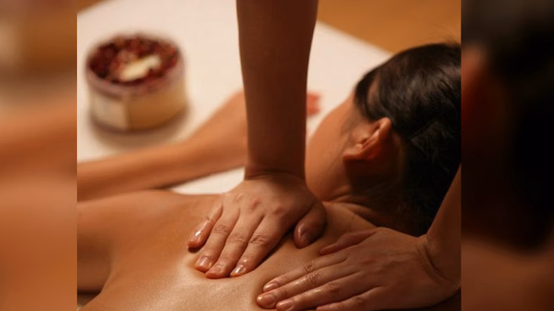Relaxing full body massage in a spa setting with warm lighting and calm atmosphere