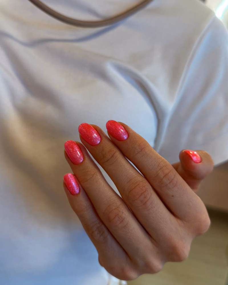 professional Russian manicure featuring clean cuticle work and shimmering pink gel nails