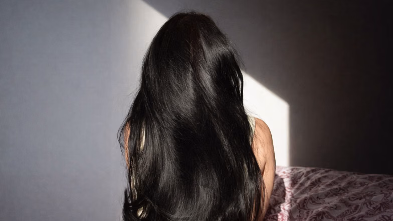 Long shiny healthy hair from the back, result of proper scalp care and treatments