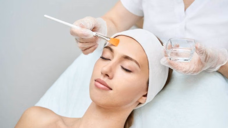Applying facial mask during professional skincare treatment in a beauty salon