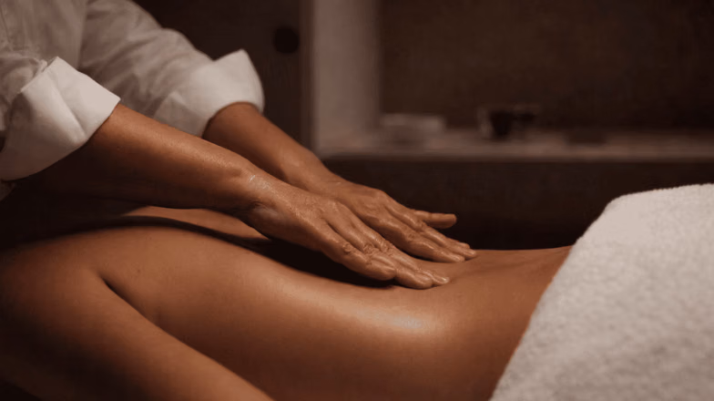 Massage therapist working on legs during professional full body massage treatment