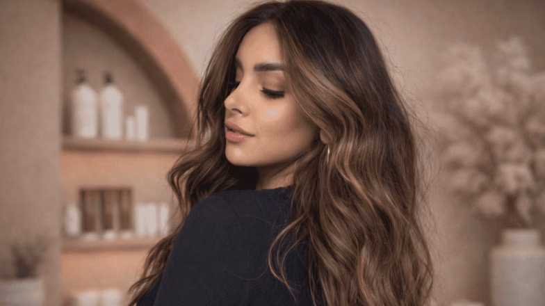 Wavy balayage hairstyle with seamless color transition and natural dimension